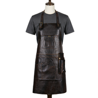 A dark brown distressed leather work apron with multiple pockets, displayed on a mannequin torso wearing a dark gray t-shirt against a plain white background.